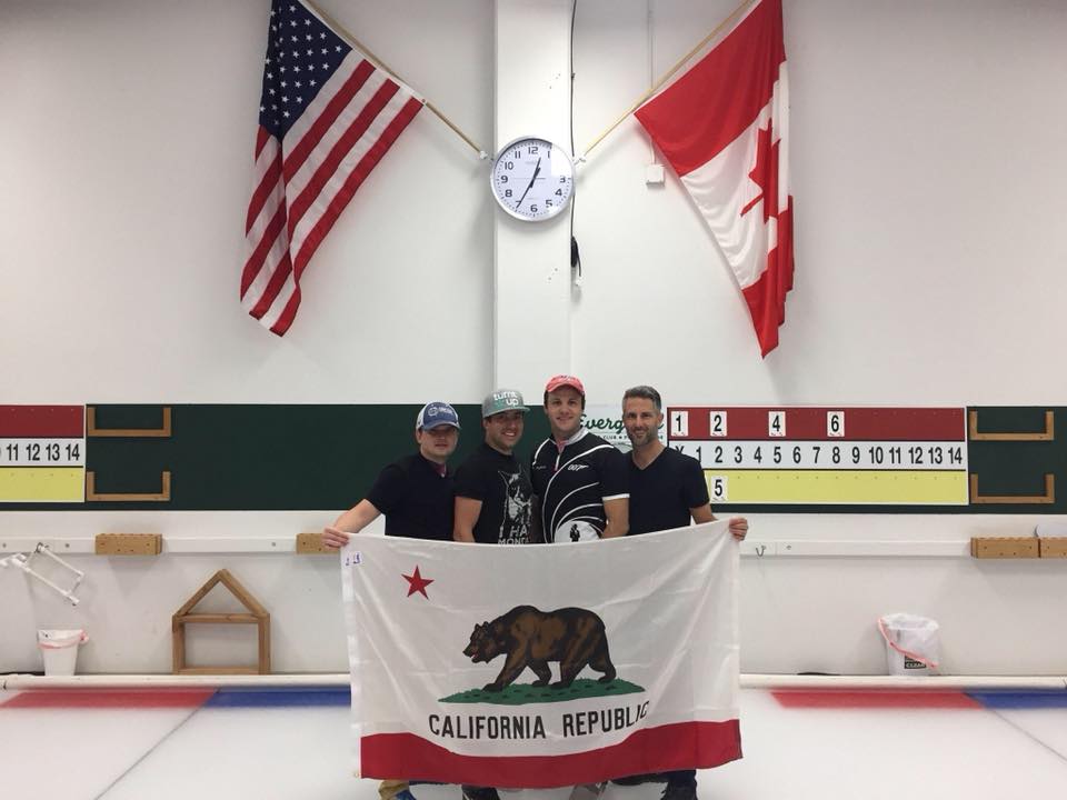 4 men stand in a curling rink holding a California flag